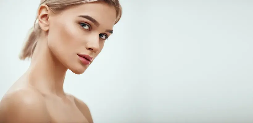 Blonde model posing against white background